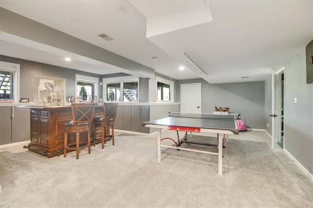 rec room featuring indoor bar, light colored carpet, and track lighting