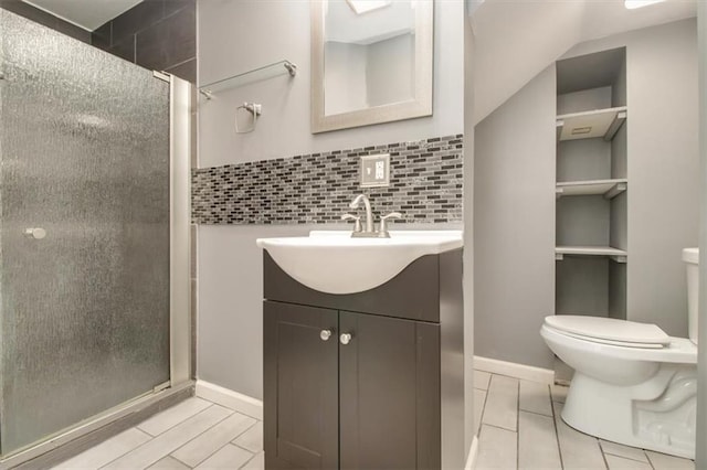 bathroom featuring tasteful backsplash, vanity, toilet, and a shower with shower door