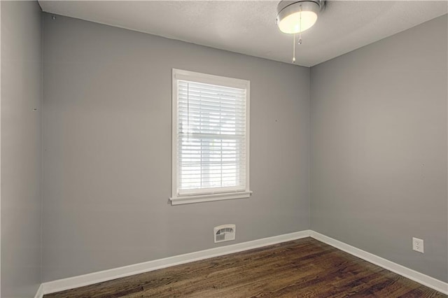 spare room featuring dark hardwood / wood-style flooring