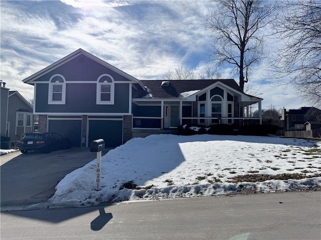 split level home featuring a garage and central air condition unit