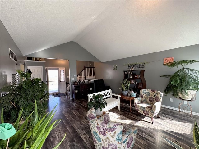 living room with vaulted ceiling, a textured ceiling, and dark hardwood / wood-style flooring