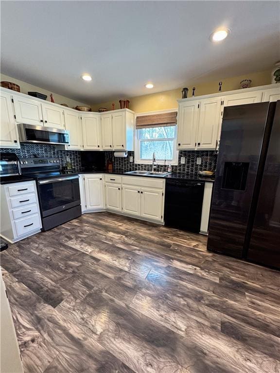 kitchen with sink, white cabinetry, dark hardwood / wood-style floors, black appliances, and decorative backsplash