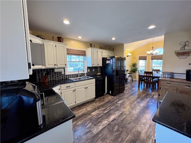 kitchen featuring sink, tasteful backsplash, black appliances, white cabinets, and decorative light fixtures