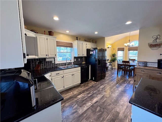 kitchen featuring dark wood-type flooring, sink, white cabinets, decorative backsplash, and black appliances