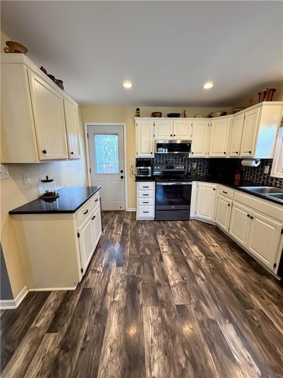 kitchen with white cabinetry, electric range, and decorative backsplash