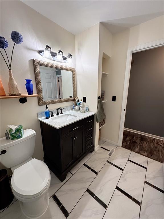 bathroom featuring vanity and toilet