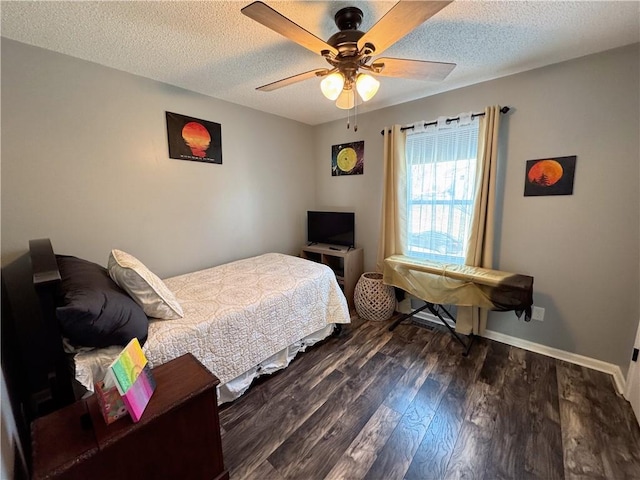 bedroom with ceiling fan, dark hardwood / wood-style floors, and a textured ceiling