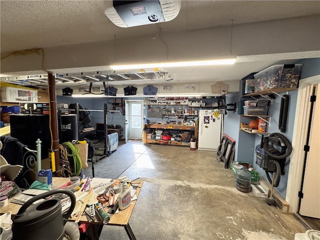 garage with white refrigerator and a garage door opener