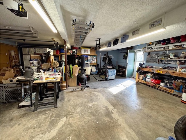 interior space featuring a workshop area, concrete floors, and a textured ceiling