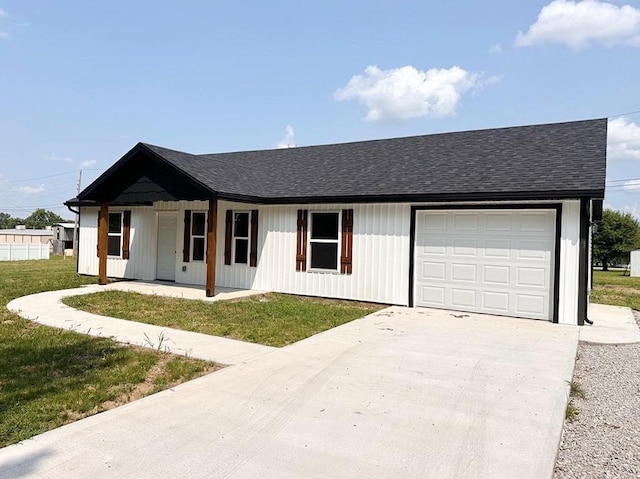 single story home featuring a porch, a garage, and a front yard