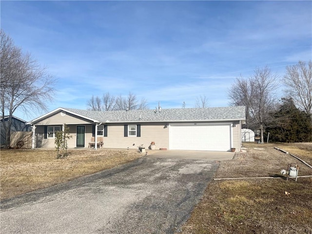 single story home with a garage and a front lawn