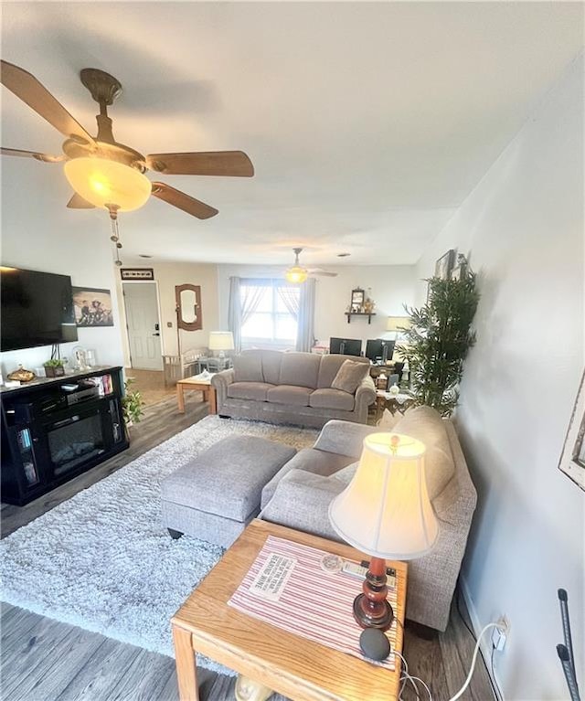 living room with hardwood / wood-style floors and ceiling fan