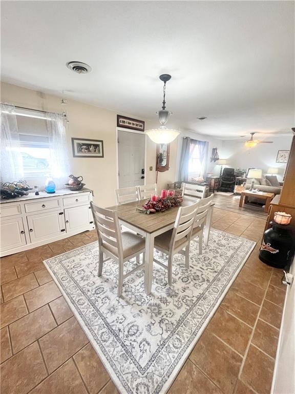 dining room featuring tile patterned floors and ceiling fan