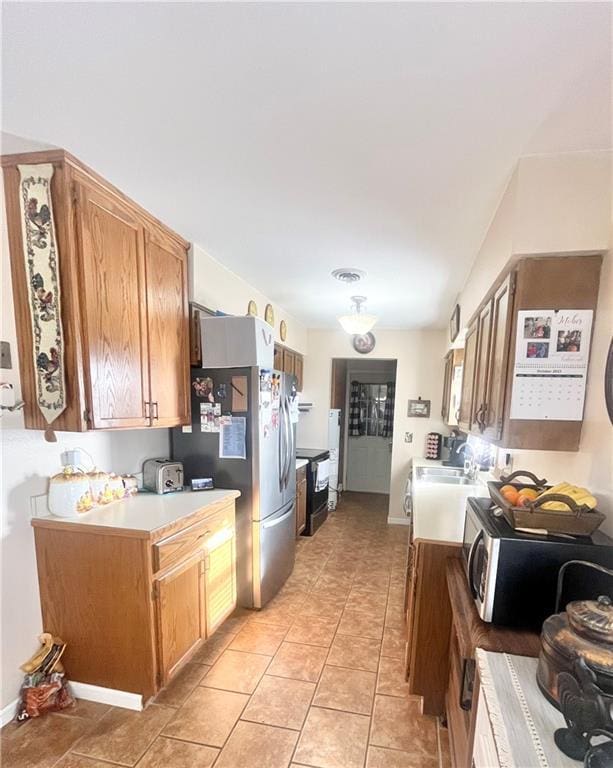 kitchen featuring stainless steel appliances and light tile patterned floors