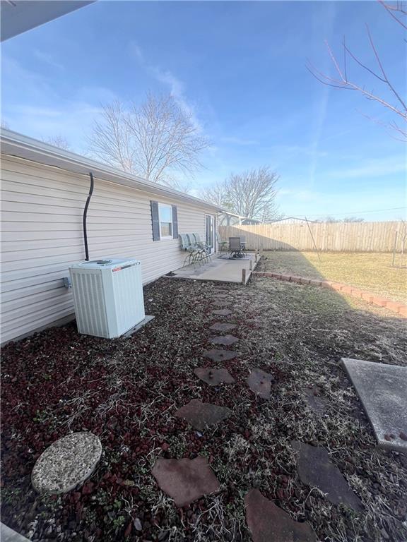 view of yard with cooling unit and a patio area