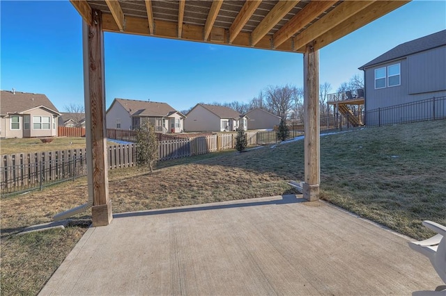view of patio featuring a fenced backyard and a residential view