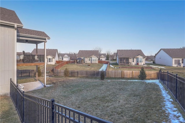 view of yard featuring a fenced backyard and a residential view