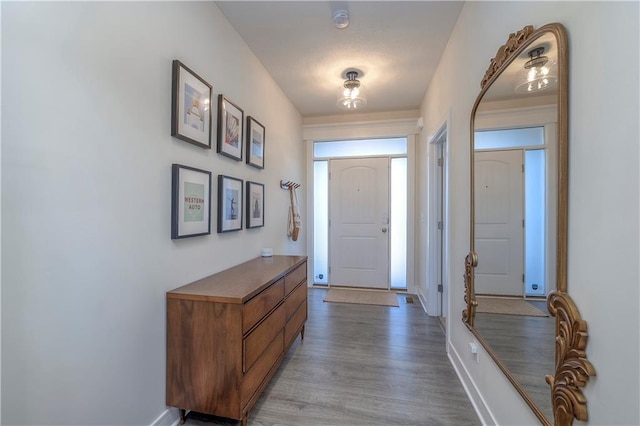 entrance foyer with baseboards and wood finished floors