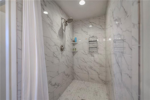 full bath with a tile shower