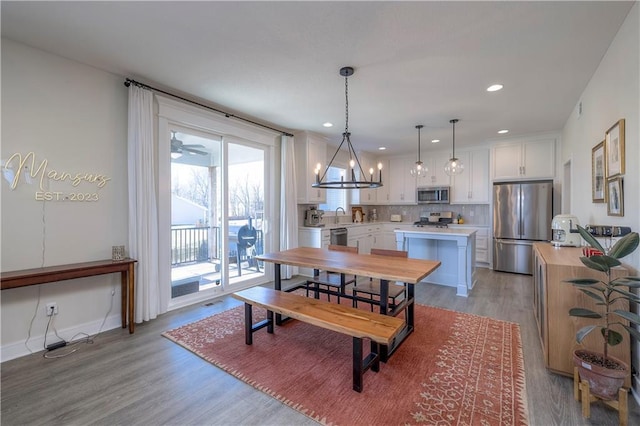 dining area with baseboards, recessed lighting, and light wood-style floors