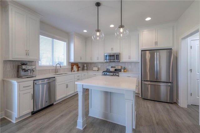 kitchen with decorative backsplash, white cabinetry, a sink, and stainless steel appliances