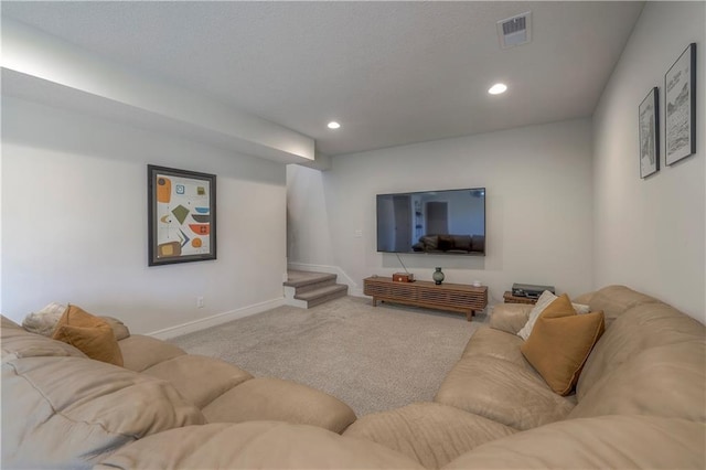 carpeted living area with baseboards, stairs, visible vents, and recessed lighting