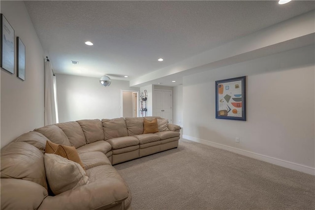 living area featuring recessed lighting, carpet floors, baseboards, and a textured ceiling