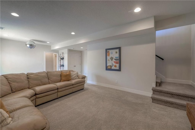 living area featuring a textured ceiling, baseboards, recessed lighting, stairway, and carpet floors