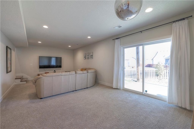 carpeted living room with baseboards, recessed lighting, and a textured ceiling