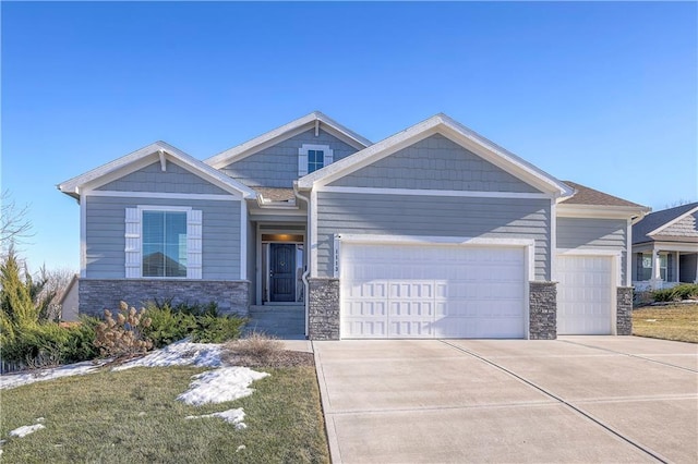 craftsman inspired home featuring stone siding, driveway, and an attached garage