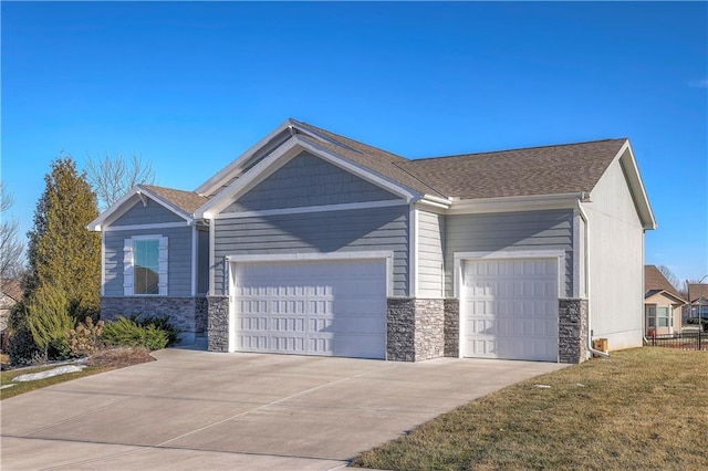 view of front facade featuring driveway, stone siding, roof with shingles, a front lawn, and a garage