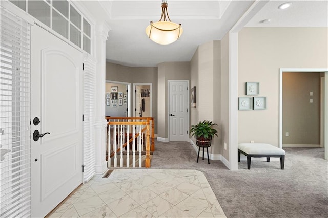 entrance foyer featuring recessed lighting, a tray ceiling, light colored carpet, and baseboards