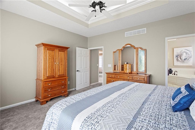 bedroom with light colored carpet, a ceiling fan, baseboards, visible vents, and a tray ceiling