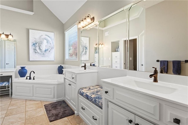 bathroom with a garden tub, two vanities, vaulted ceiling, a sink, and tile patterned flooring