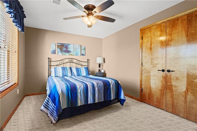 bedroom with ceiling fan, carpet, visible vents, and baseboards