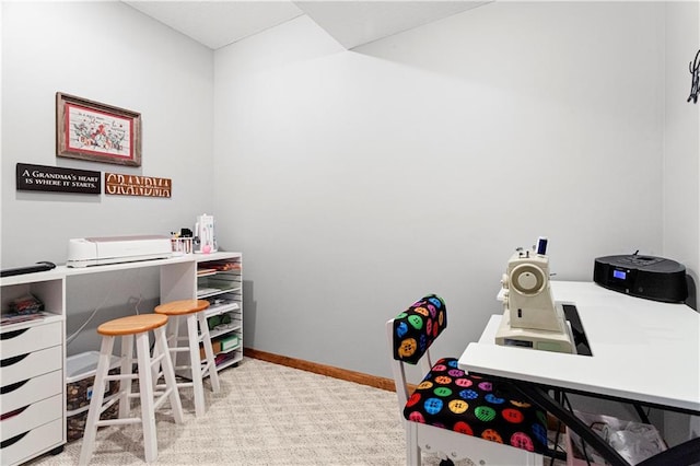 office space with baseboards and light colored carpet