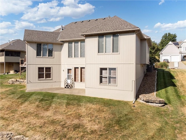 back of property featuring central AC, a lawn, and a patio area