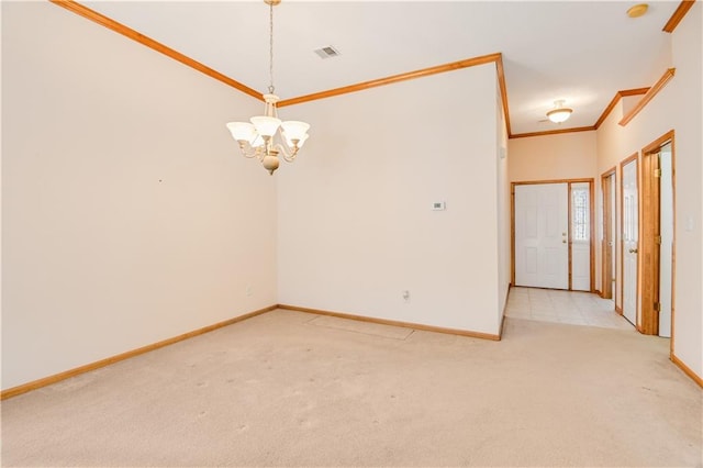 spare room with light colored carpet, ornamental molding, and a notable chandelier