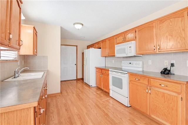 kitchen with tasteful backsplash, sink, white appliances, and light wood-type flooring