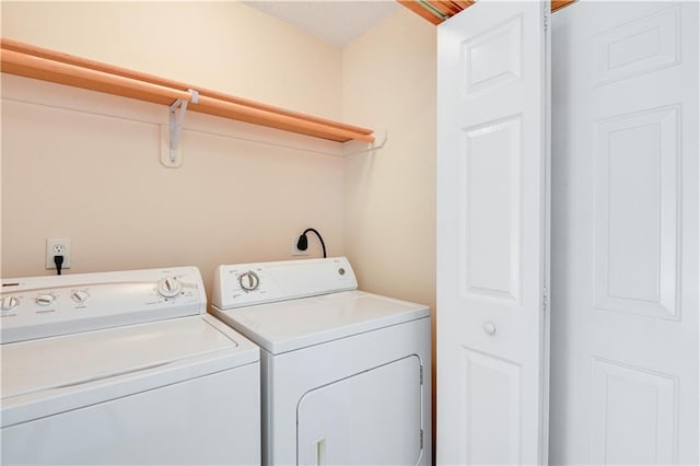 clothes washing area with washer and clothes dryer