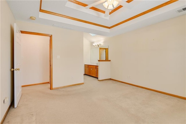 empty room featuring ceiling fan, a raised ceiling, and light carpet