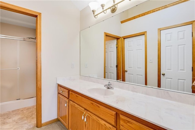 bathroom with vanity and a shower with shower door