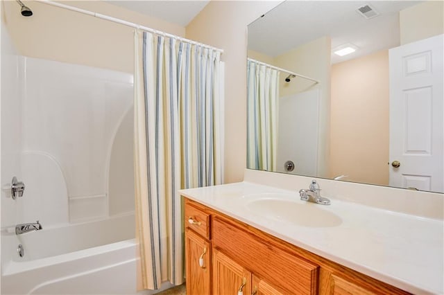 bathroom featuring vanity and shower / bath combination with curtain