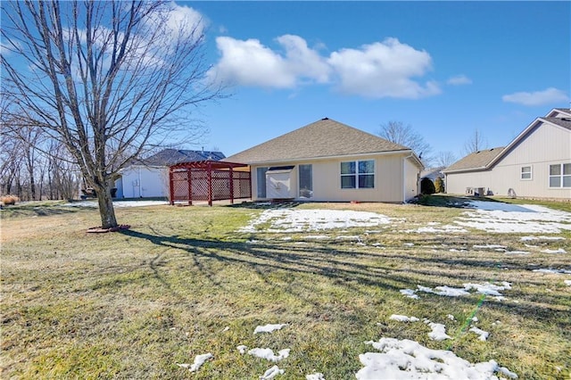 rear view of house with a yard