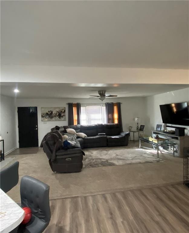 living room featuring wood-type flooring and ceiling fan