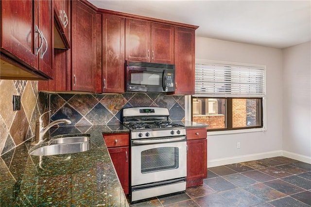 kitchen featuring tasteful backsplash, dark stone counters, sink, and stainless steel gas stove