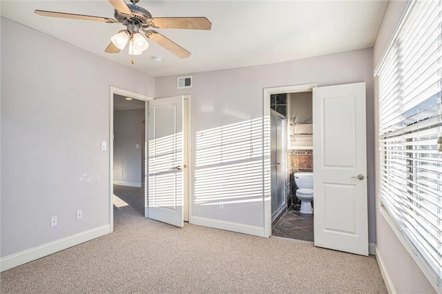 bedroom featuring ceiling fan, ensuite bath, and carpet