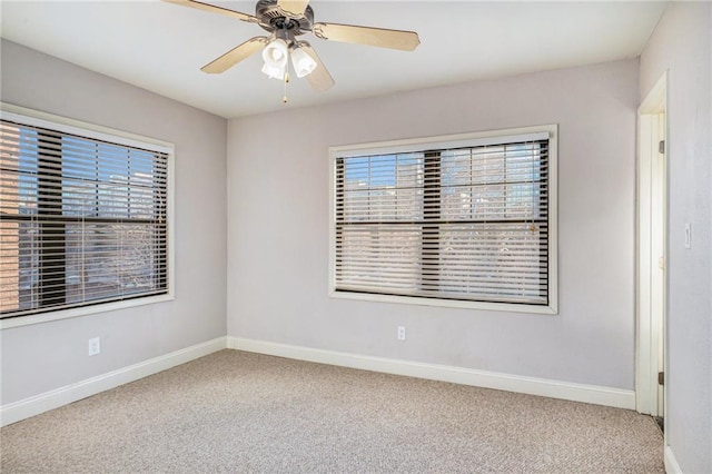 carpeted spare room with ceiling fan