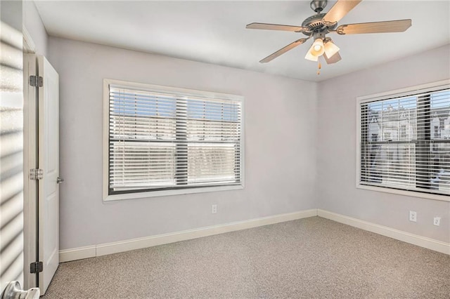 carpeted empty room featuring ceiling fan