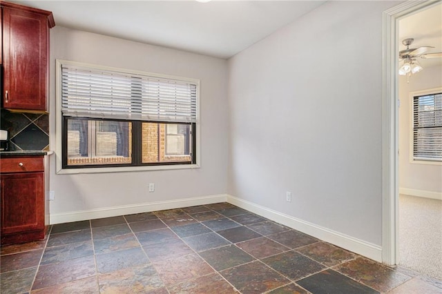 1102 W 46th St Unit 3, Kansas City, MO 64111 - unfurnished room featuring stone tile floors and ceiling fan